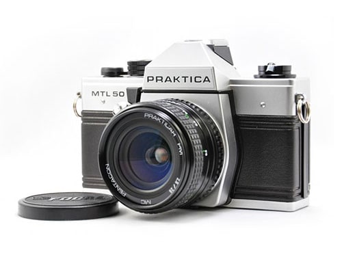 Vintage Praktica MTL 50 camera with lens and cap. Ideal for photography enthusiasts seeking classic gear.