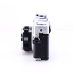 Side view of OLYMPUS 35DC film rangefinder camera showing lens and controls.