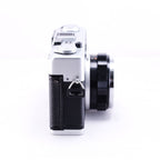 Side view of OLYMPUS 35DC black film rangefinder camera showcasing its sleek design and lens.