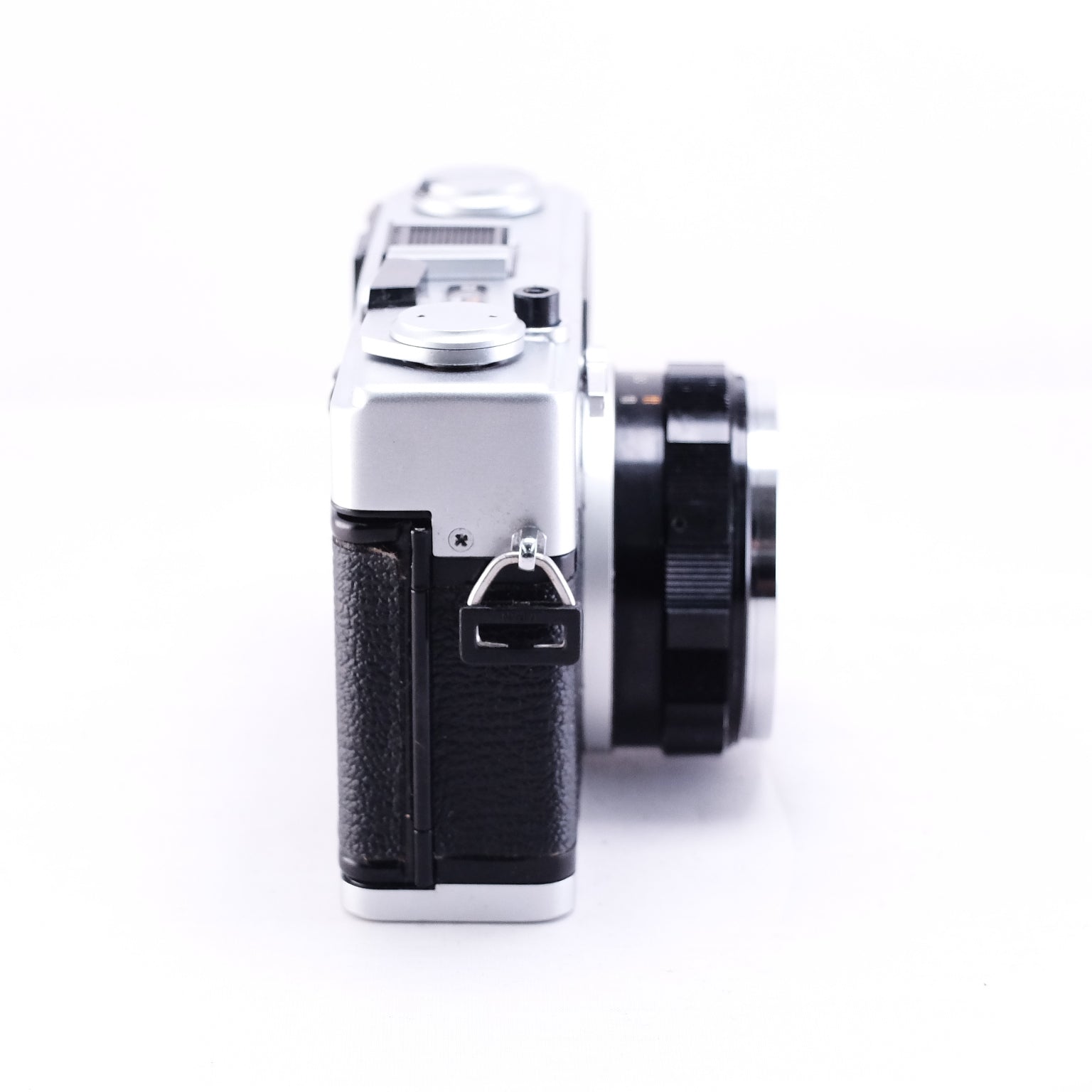 Side view of OLYMPUS 35DC black film rangefinder camera showcasing its sleek design and lens.